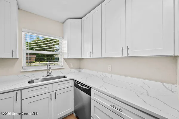 a kitchen with appliances cabinets and a sink