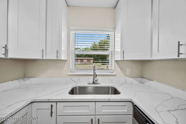 a kitchen with appliances cabinets and a sink