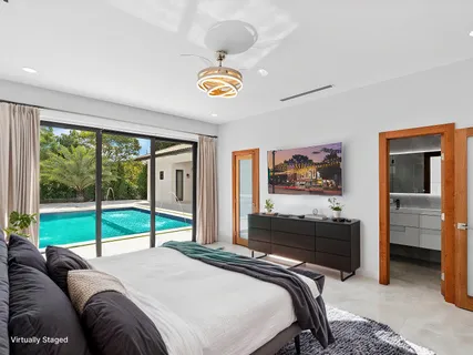 a bedroom with a bed and a large window