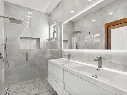 a bathroom with a sink shower and a mirror