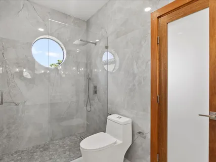 a bathroom with a toilet a sink and shower