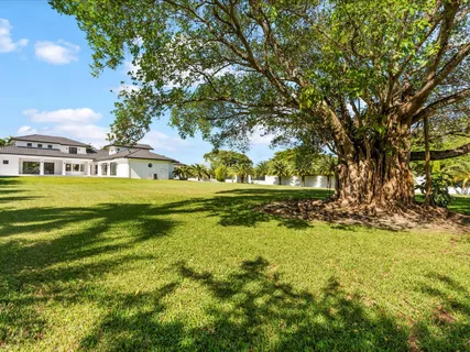 a house view with swimming pool in front of it