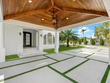 a swimming pool with yard in front of it