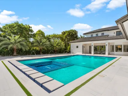 a view of a pool with a yard
