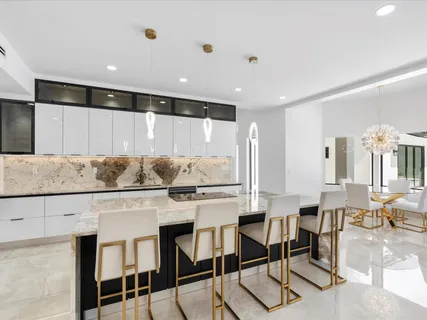 a kitchen with a table chairs stove and cabinets