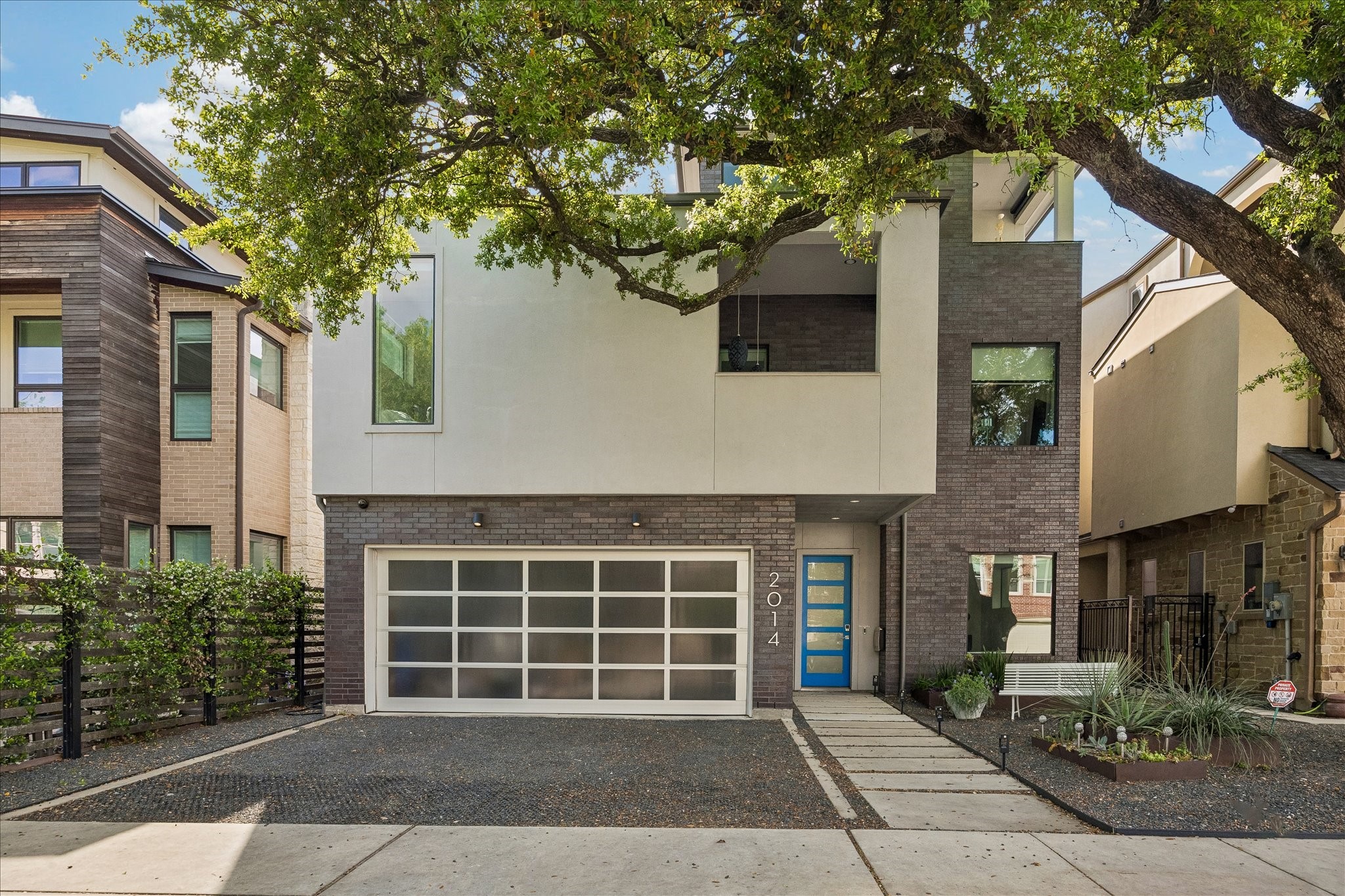 2014 Park Street Houston, TX 77019 - Photo 3 of 40 Experience modern elegance with sharp, clean lines and a contemporary feel, all under the inviting canopy of a mature oak tree.