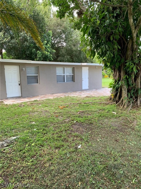 4513 Luckett Road Fort Myers, FL 33905 - Photo 1 of 20 a backyard of a house with plants and large tree