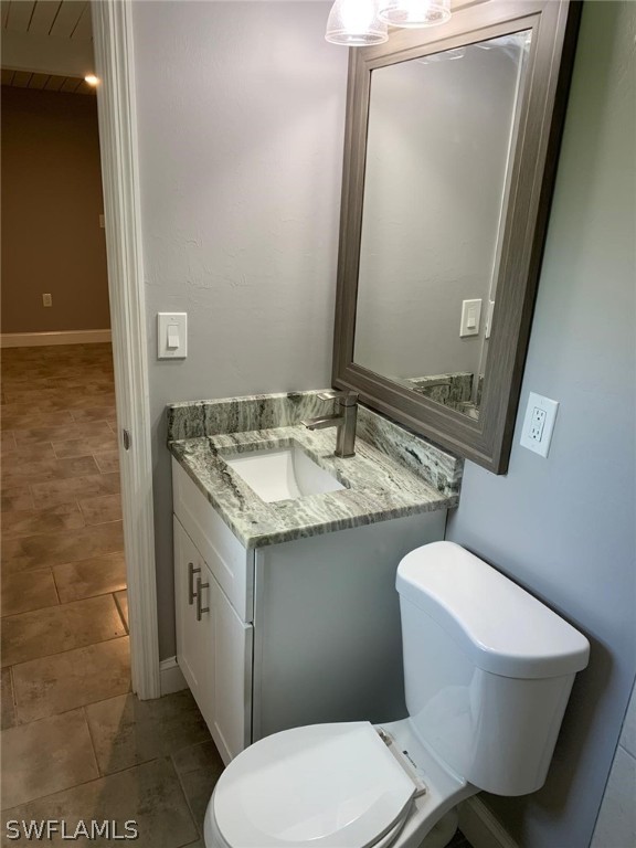 4513 Luckett Road Fort Myers, FL 33905 - Photo 18 of 20 a bathroom with a granite countertop toilet sink and mirror