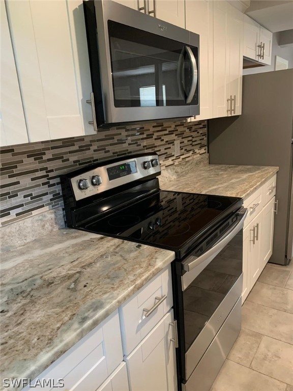 4513 Luckett Road Fort Myers, FL 33905 - Photo 7 of 20 a stove top oven sitting inside of a kitchen