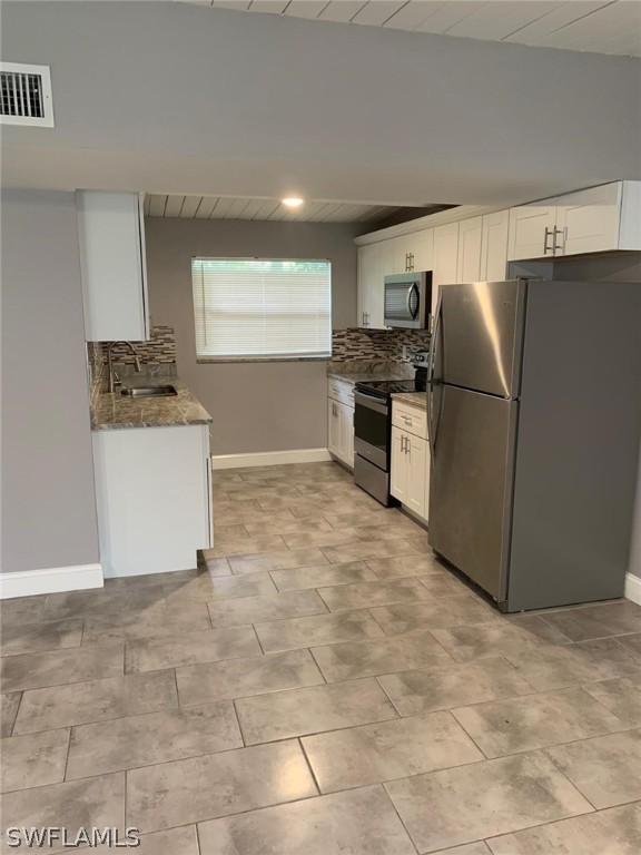 4513 Luckett Road Fort Myers, FL 33905 - Photo 9 of 20 a kitchen with a refrigerator and a stove