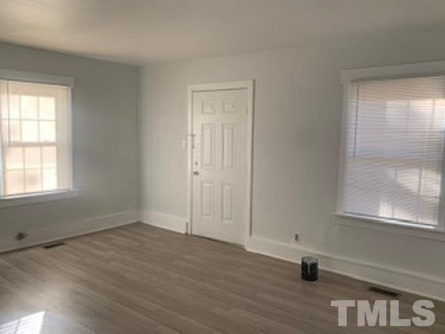1704 Robinhood Road Durham, NC 27701 - Photo 3 of 18 an empty room with wooden floor and windows