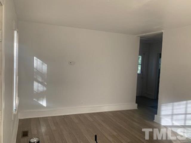 1704 Robinhood Road Durham, NC 27701 - Photo 5 of 18 an empty room with wooden floor and closet