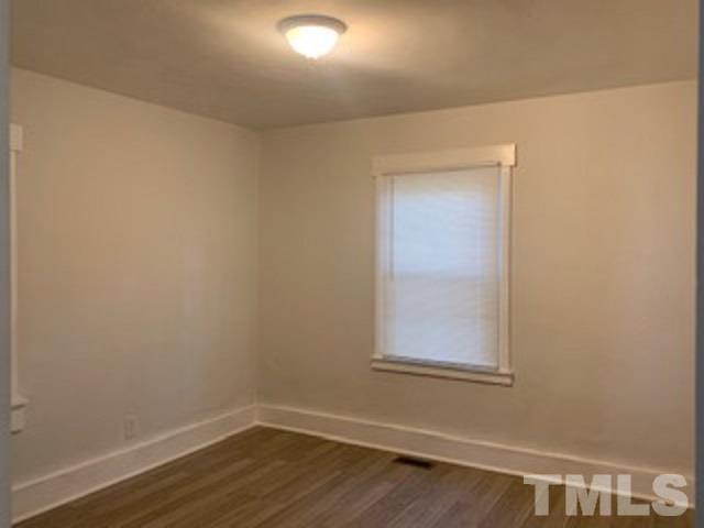 1704 Robinhood Road Durham, NC 27701 - Photo 6 of 18 a view of a small space with wooden floor and a window