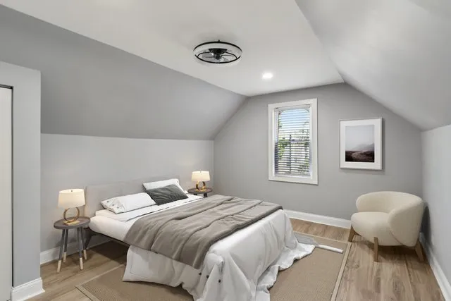 a bedroom with a bed and wooden floor