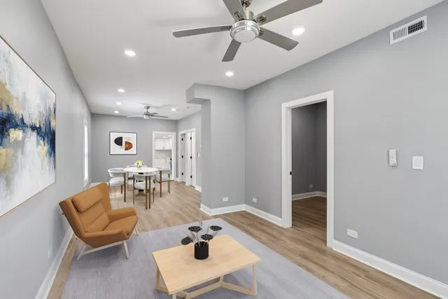 a living room with furniture and wooden floor