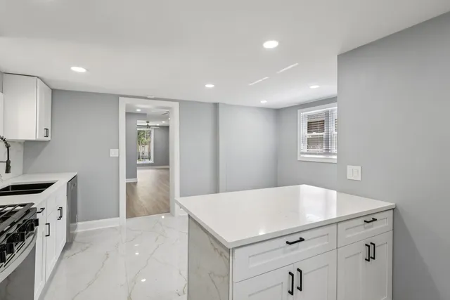 a kitchen with a sink a stove and cabinets