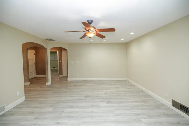 a kitchen with stainless steel appliances granite countertop a sink stove and cabinets
