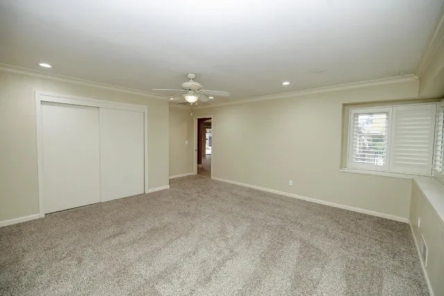a spacious bathroom with a granite countertop sink a mirror and a shower