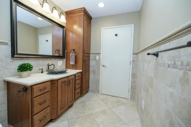 a bathroom with a sink a toilet and mirror