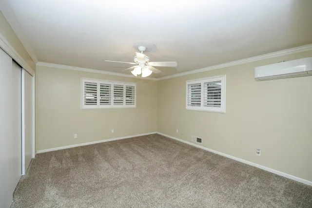 a view of a livingroom with furniture and a ceiling fan