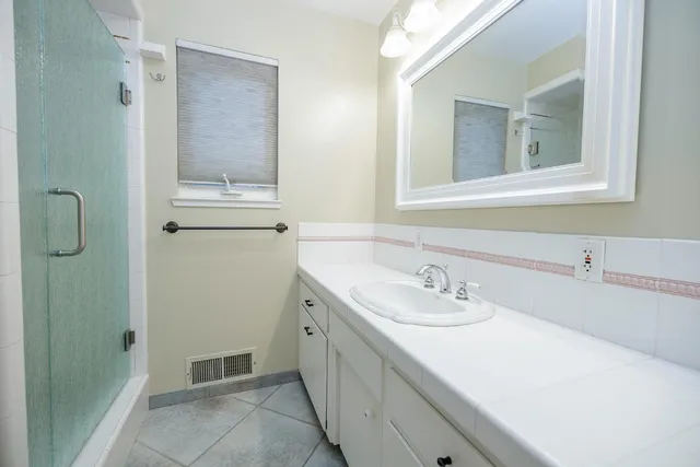a view of a kitchen with a sink a ceiling fan and wooden floor