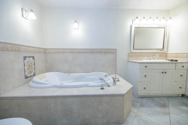 a view of a livingroom with a kitchen and a stove wooden floor cabinets