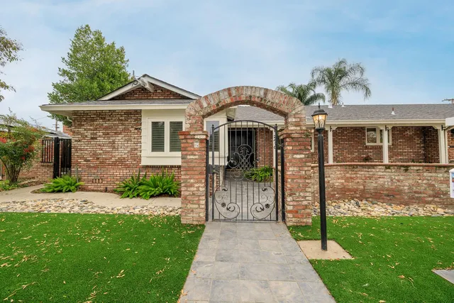 a view of a house with backyard and sitting area