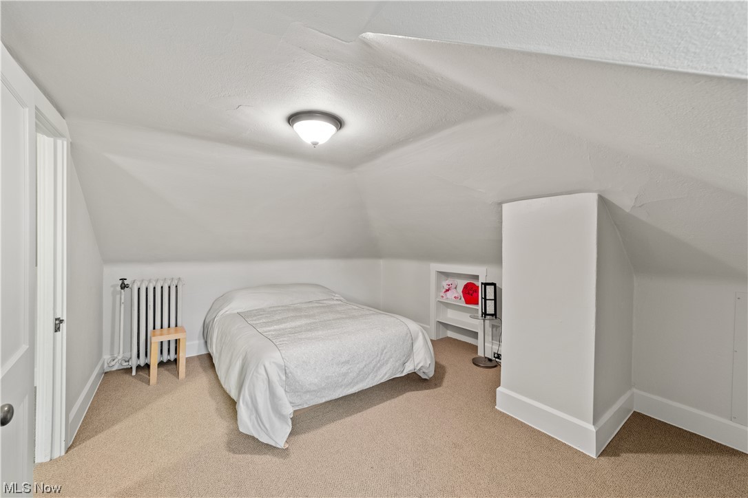 2745 Leighton Road Cleveland, OH 44120 - Photo 35 of 46 Carpeted bedroom with lofted ceiling, a textured ceiling, and radiator