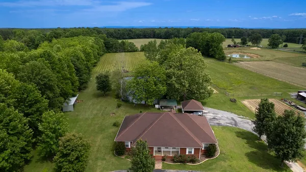 an aerial view of a house with a yard
