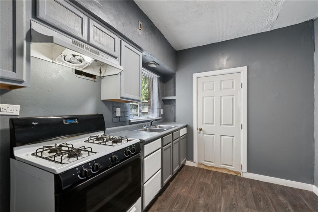 214 Fleet Street Braddock, PA 15104 - Photo 12 of 31 a kitchen with a stove and a refrigerator