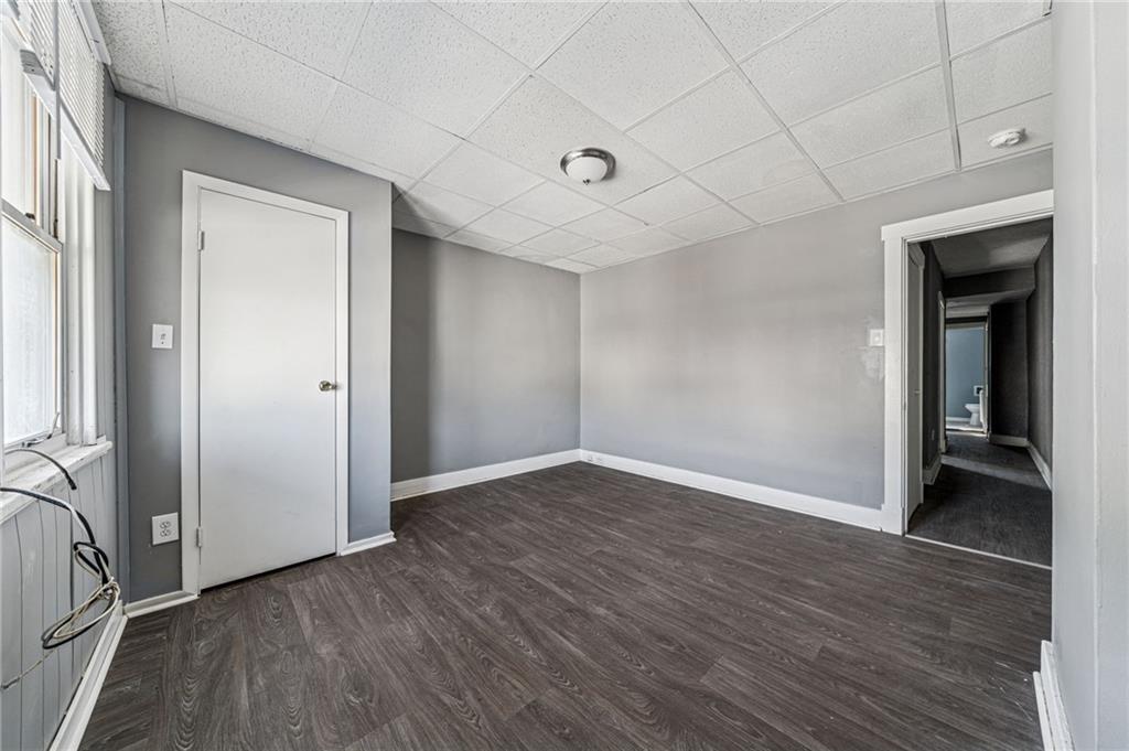 214 Fleet Street Braddock, PA 15104 - Photo 18 of 31 an empty room with wooden floor and windows