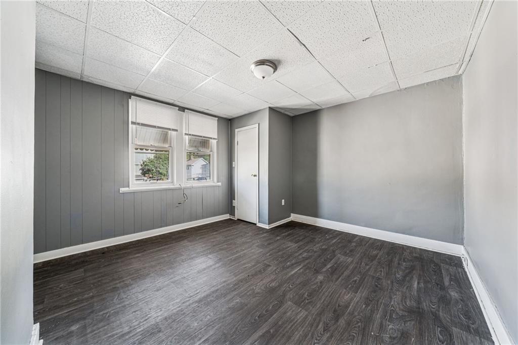 214 Fleet Street Braddock, PA 15104 - Photo 19 of 31 an empty room with wooden floor and windows