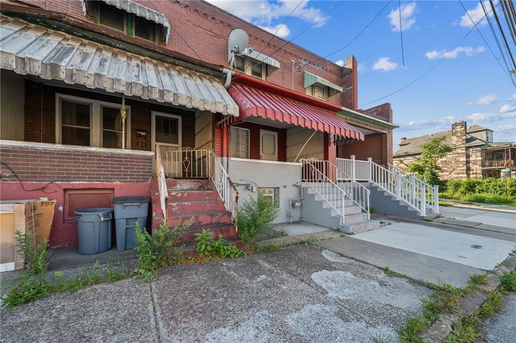 214 Fleet Street Braddock, PA 15104 - Photo 29 of 31 a front view of a building with a garden and plants