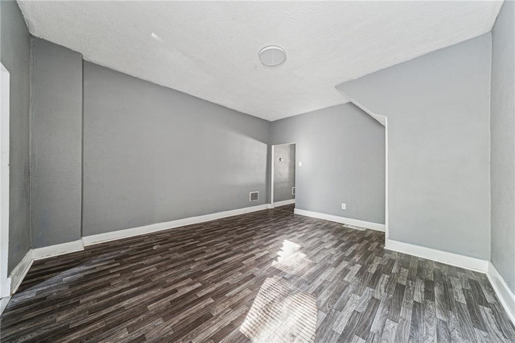 214 Fleet Street Braddock, PA 15104 - Photo 9 of 31 a view of an empty room and wooden floor