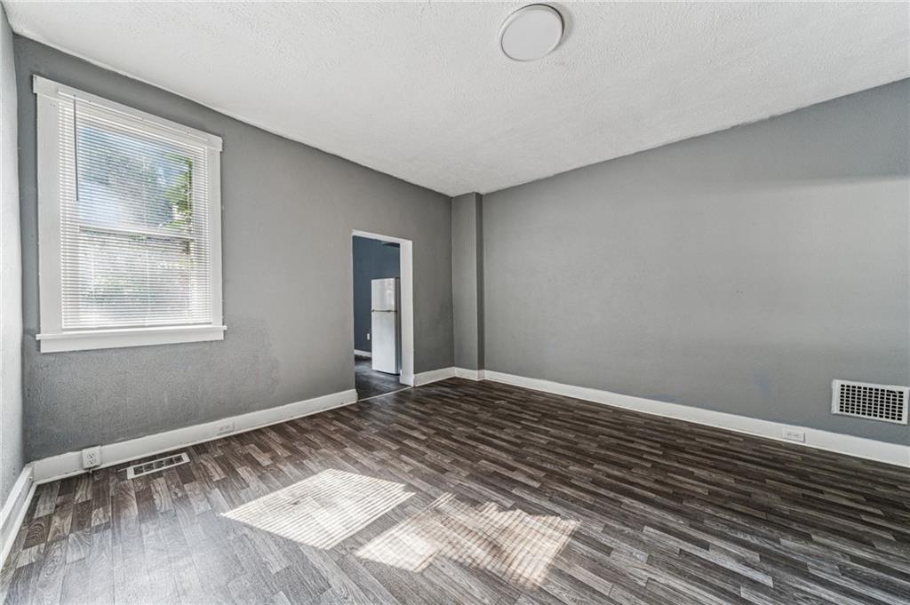 214 Fleet Street Braddock, PA 15104 - Photo 10 of 31 a view of an empty room with wooden floor and a window