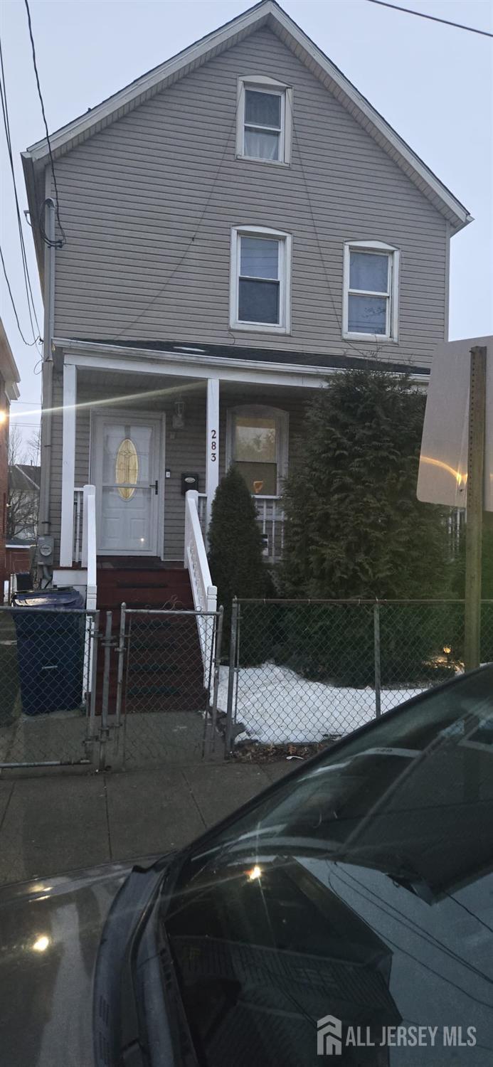 283 Washington Street Perth Amboy, NJ 08861 - Photo 1 of 15 a front view of a house with parking