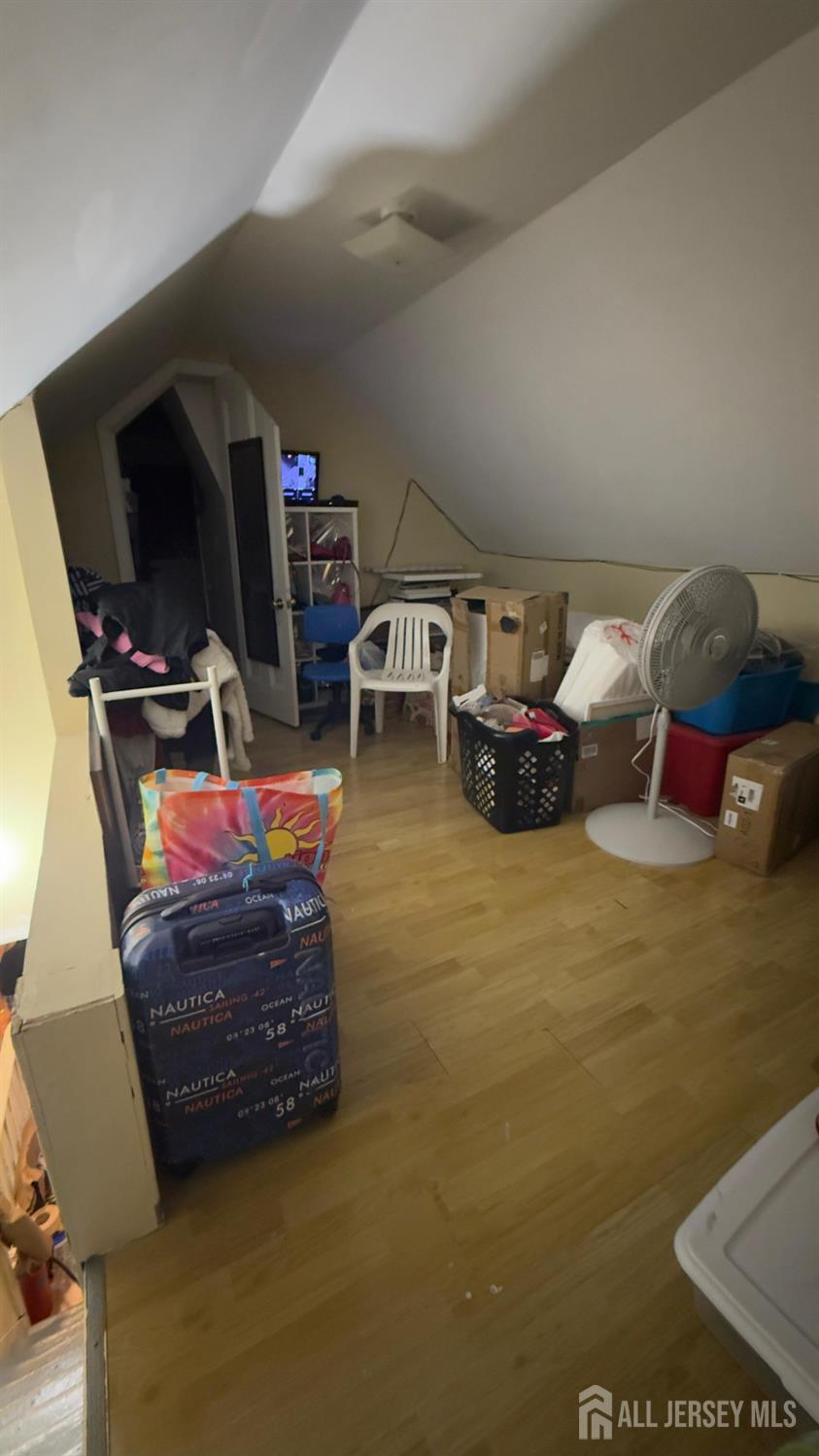 283 Washington Street Perth Amboy, NJ 08861 - Photo 13 of 15 a living room with furniture and a flat screen tv