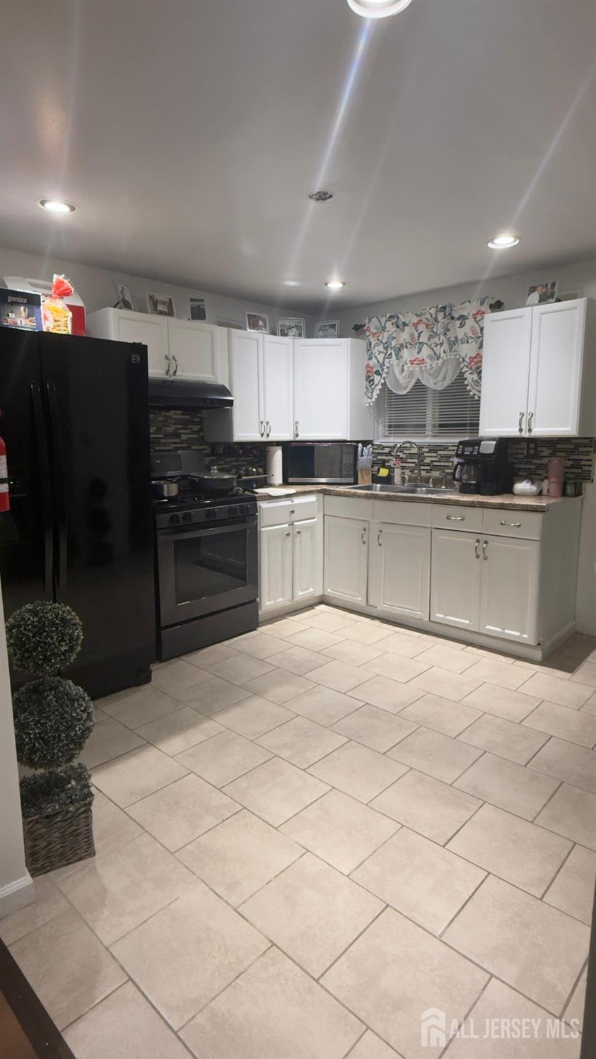 283 Washington Street Perth Amboy, NJ 08861 - Photo 4 of 15 a kitchen with stainless steel appliances granite countertop a refrigerator and a stove top oven