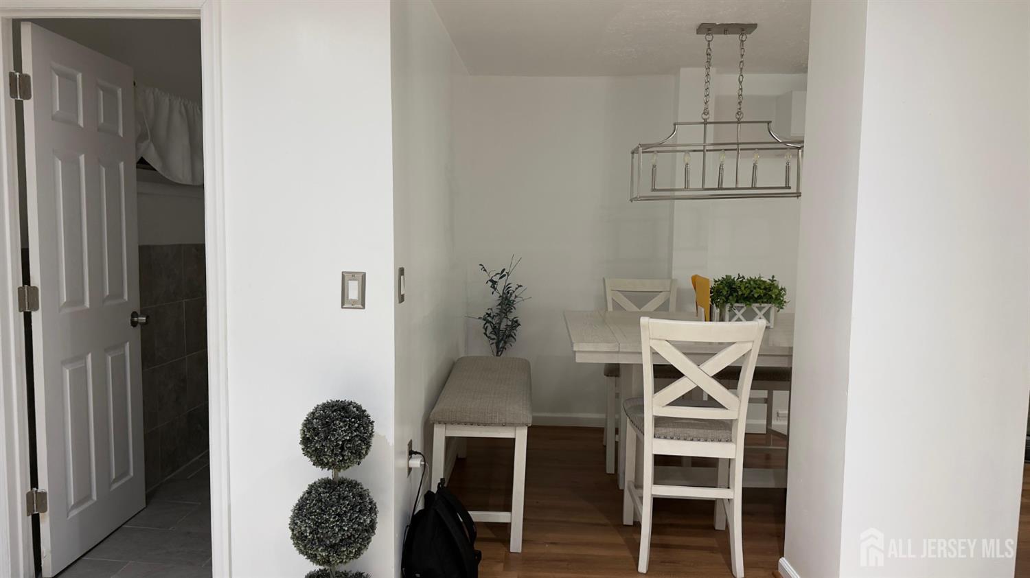 283 Washington Street Perth Amboy, NJ 08861 - Photo 6 of 15 a table with a vase and flowers on it