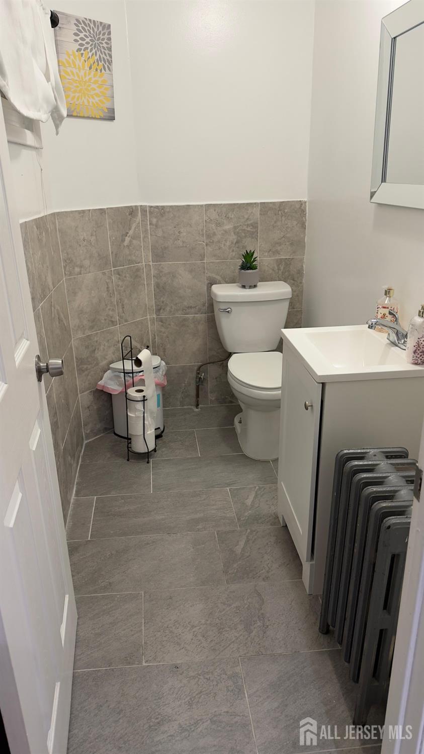 283 Washington Street Perth Amboy, NJ 08861 - Photo 7 of 15 a bathroom with a sink and a toilet