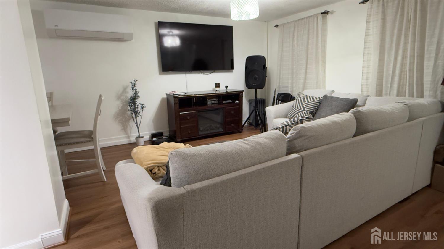 283 Washington Street Perth Amboy, NJ 08861 - Photo 8 of 15 a living room with furniture and a flat screen tv