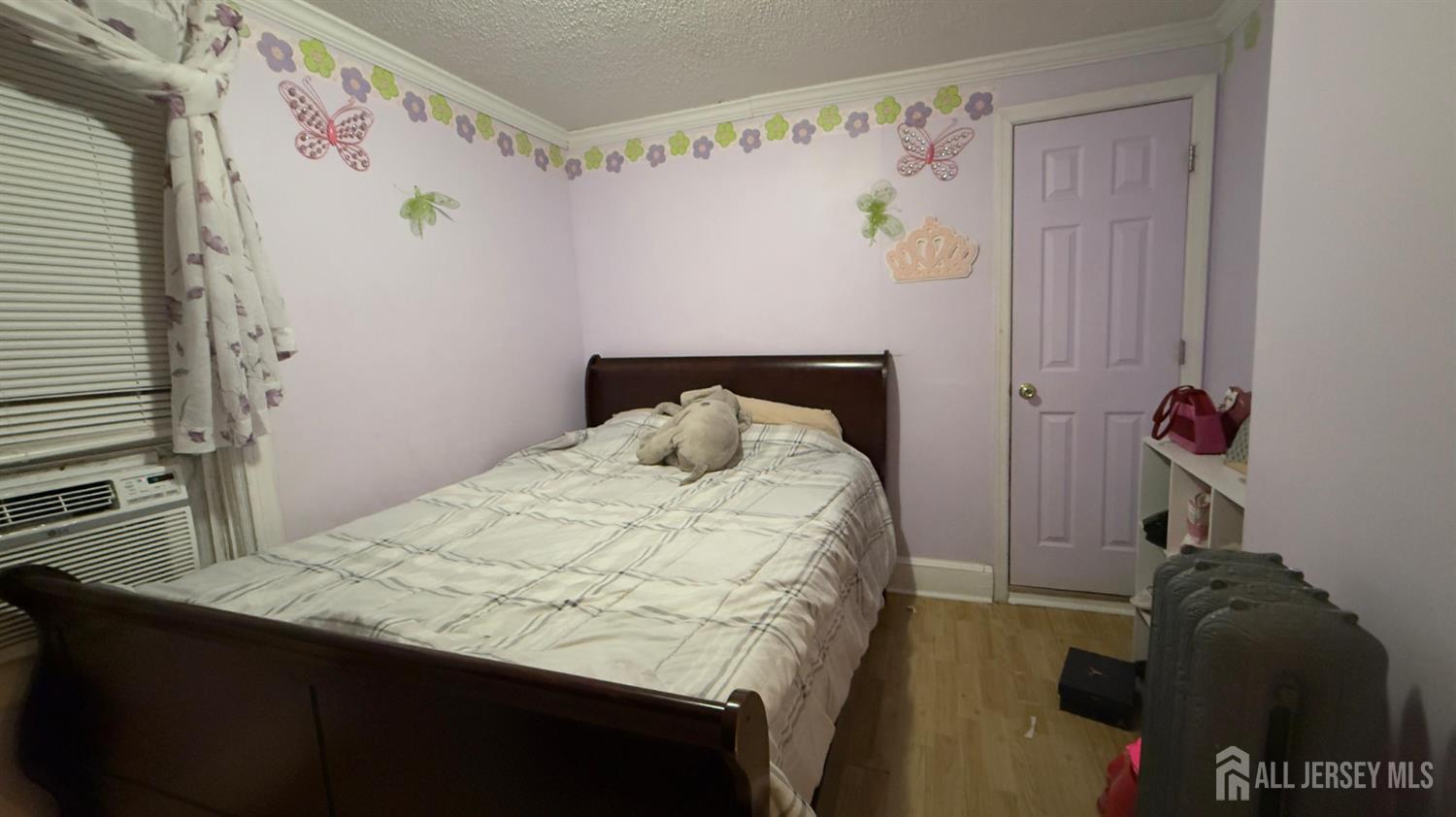 283 Washington Street Perth Amboy, NJ 08861 - Photo 9 of 15 a bedroom with a bed and a window