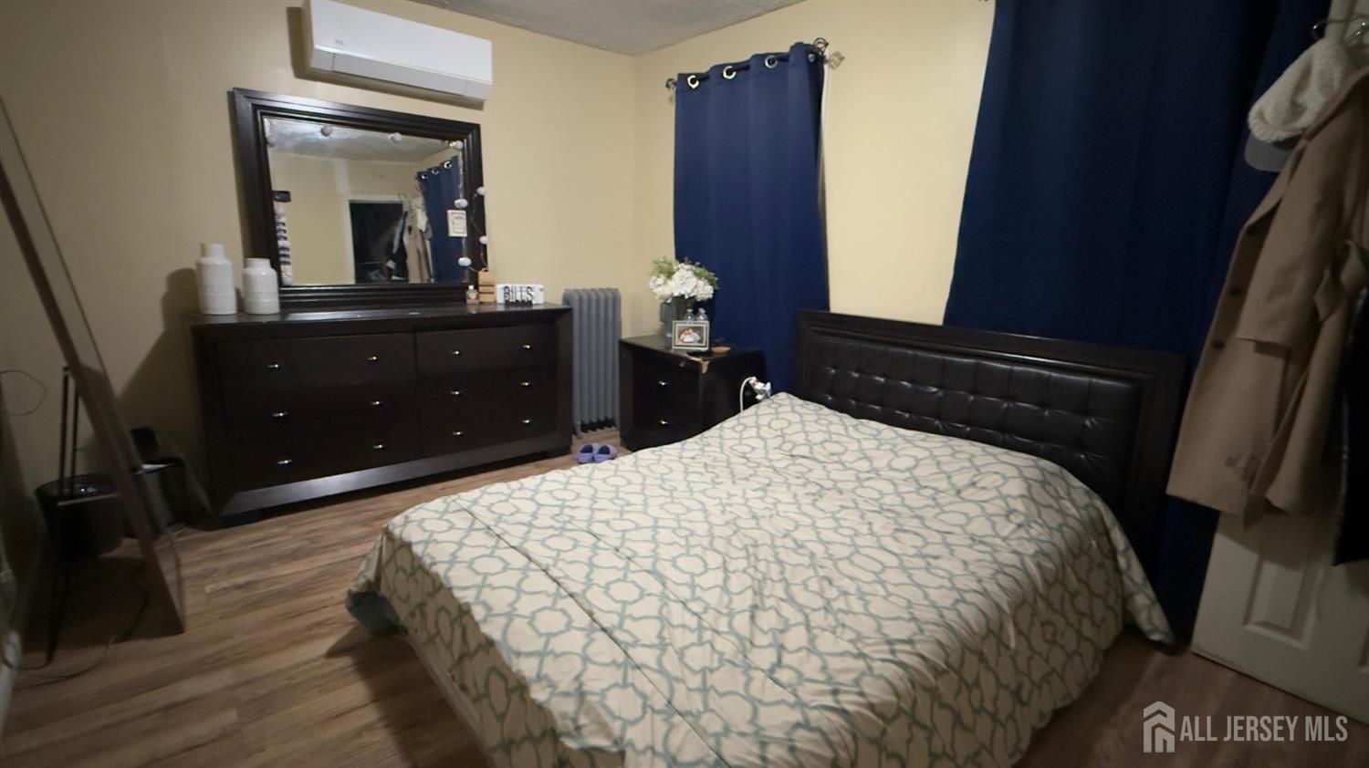 283 Washington Street Perth Amboy, NJ 08861 - Photo 10 of 15 a bedroom with a bed and a mirror