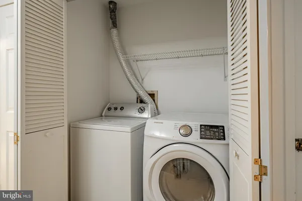 a view of storage and utility room with washer and dryer