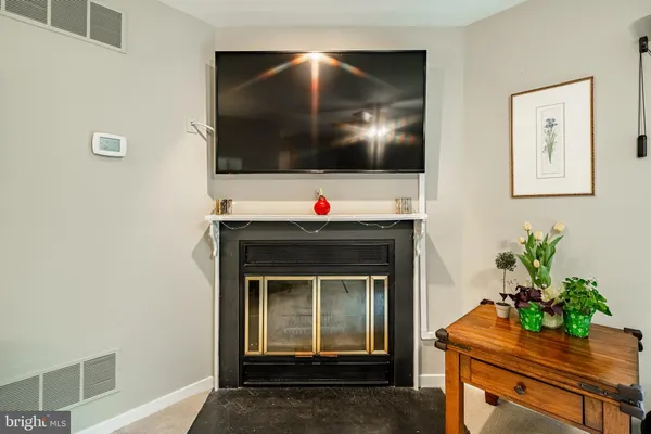 a living room with a flat screen tv and a fireplace