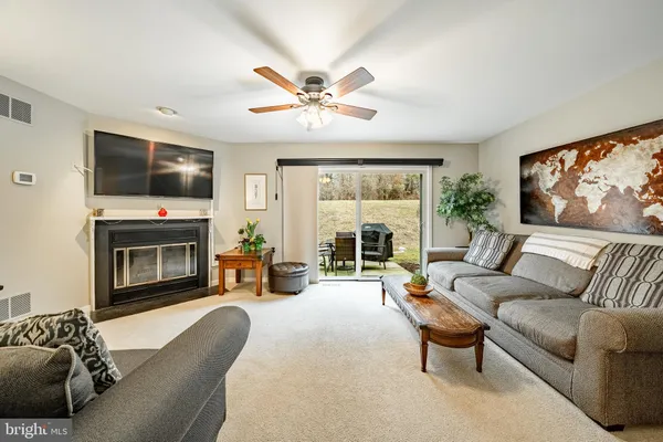 a living room with furniture a fireplace and a flat screen tv