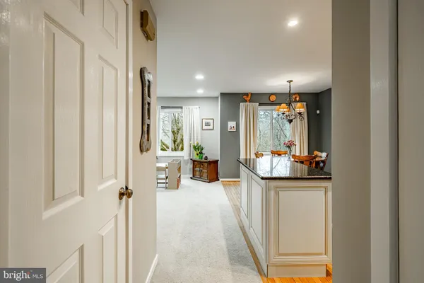 a view of a hallway and a livingroom with furniture