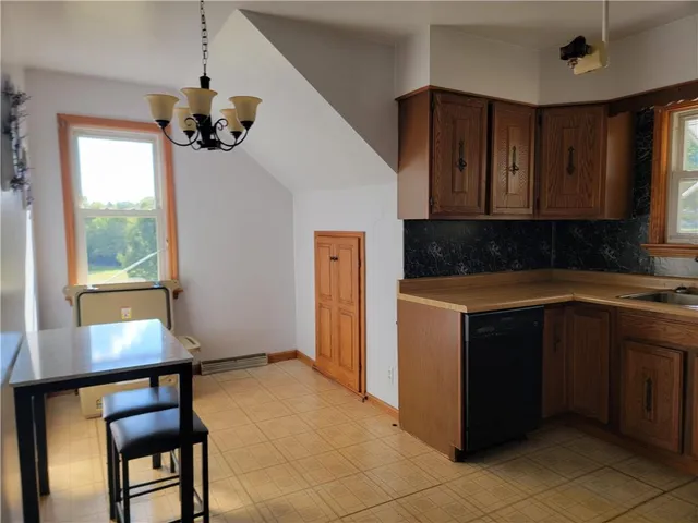 a kitchen with stainless steel appliances granite countertop a sink counter space cabinets and a window