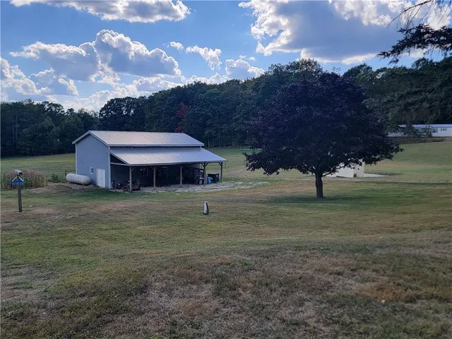 a backyard of a house with table and chairs