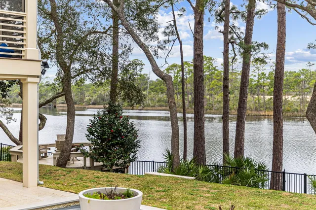 a large white kitchen with sink a stove and a refrigerator